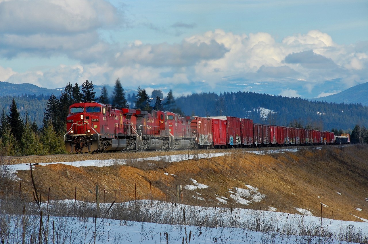 A westbound mixed freight is climbing towards Notch Hill on the north track.
