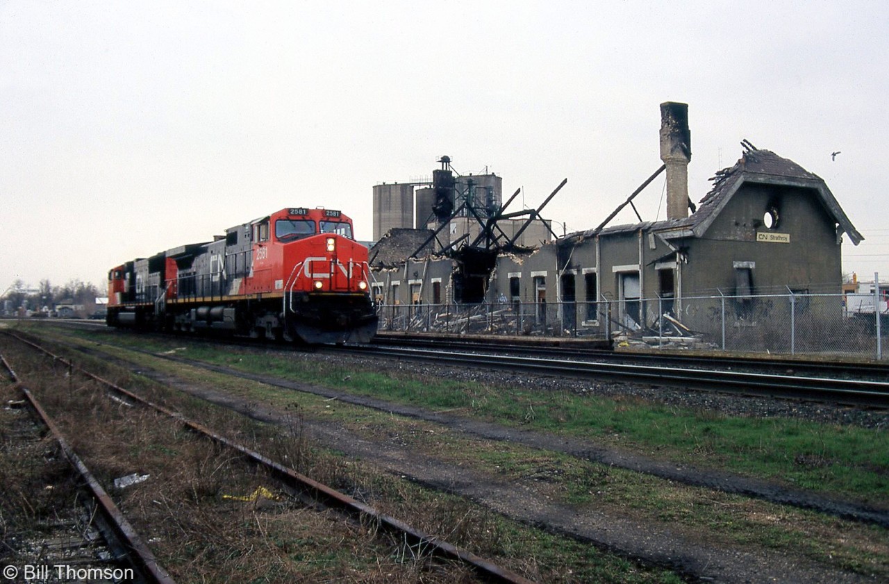 A CN C44-9W and SD75I on a freight pass by the recently burnt Strathroy Station at Mile 20 CN Strathroy Sub.

The 117-year old structure was built by the Grand Trunk Railway in 1887, but out of use for years before the fire that doomed it. Three local 12-year old boys were later charged with arson.