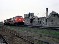 A CN C44-9W and SD75I on a freight pass by the recently burnt Strathroy Station at Mile 20 CN Strathroy Sub.
<br><br>
The 117-year old structure was built by the Grand Trunk Railway in 1887, but out of use for years before the fire that doomed it. Three local 12-year old boys were later charged with arson.