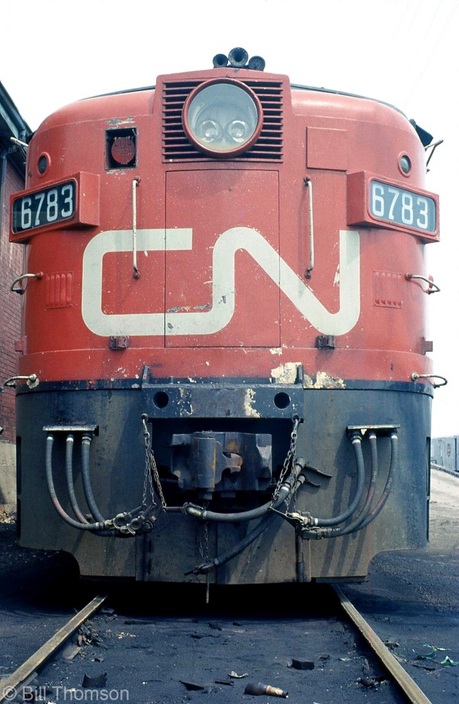 Ray Patton's distinctive Alco nose design and styling dating from the 1940's lived on long after most American roads retired and traded in their FA & PA locomotives: Canadian National's fleet of MLW-built FPA4's (and matching FPB4 B-units) had long lives hauling passenger trains in southern Ontario corridor service and in eastern Canada, going on to serve national carrier VIA Rail until they were retired and sold off in the late 80's (ironically, many went to American tourist roads and shortlines). Here, FPA-4 6783 and its well-worn nose sit parked overnight in Guelph, in May of 1972.
