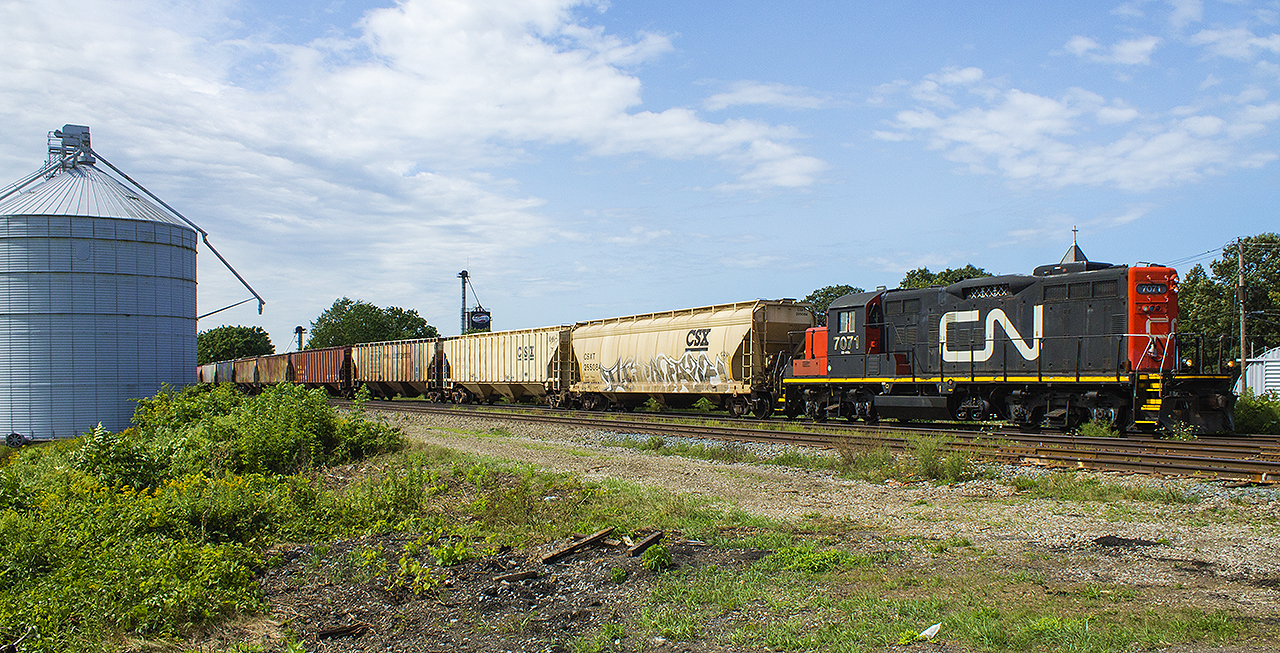 CN 7071 could tell a lot of stories through it's 58 year history. One of the first generation GP9's, it was rebuilt and is still in regular use along the Chatham Subdivision. Here, it is seen coupled back onto it's train after servicing the Agris facility. The Windsor crew operating the train today is wasting no time, as they start to gain momentum. They won't have far to go, as they will perform further switching duties just on the other side of Hwy. 21 (Note the debris in the foreground. This was left after the closing of Hwy 21 at the tracks in early August, as CN rebuilt the crossing so that drivers would not have to further endure a bumpy ride across all three tracks).