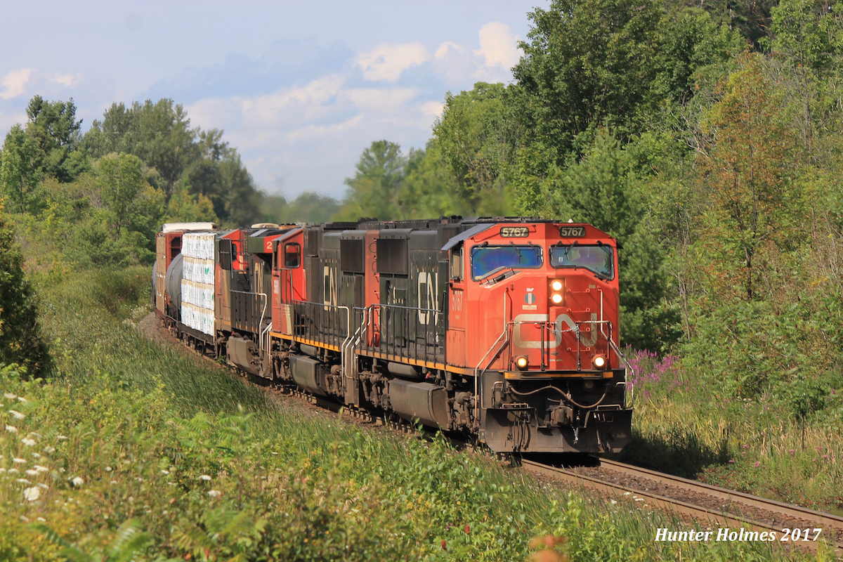 CN A435 takes the approach to Mansewood "with the arrow" as it rounds the bend on an August afternoon that couldn't have cooperated better for us, it poured rain between trains but every time one was near the sun would break through just in time for photos.