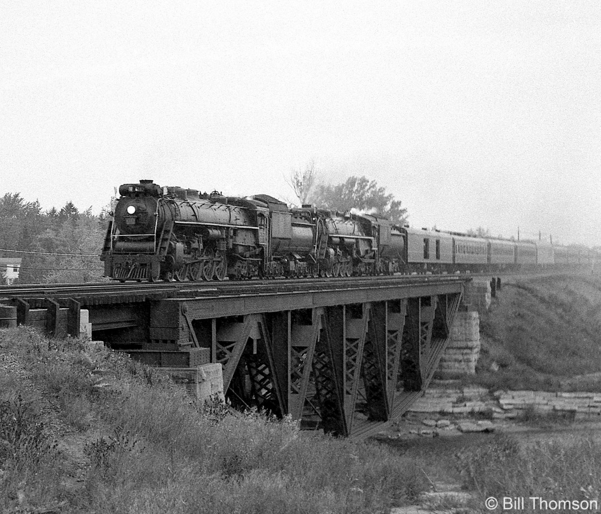 A Canadian National steam excursion train doubleheaded by CN Northerns 6167 and 6218 heads westbound on the Oakville Sub, crossing the Credit River bridge in Port Credit, enroute to Paris Junction on September 27th 1964.