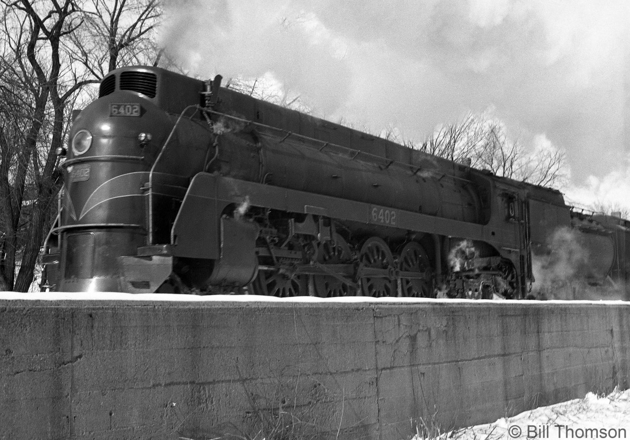 Sleek semi-streamlined CN U4a-class 4-8-4 Northern 6402, one of only 5 owned by CN (built by MLW in 1936, two years later 6 similar units would be built by Lima for the GTW) is seen pulling out of Guelph Station on a wintry day in 1949.