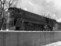 Sleek semi-streamlined CN U4a-class 4-8-4 Northern 6402, one of only 5 owned by CN (built by MLW in 1936, two years later 6 similar units would be built by Lima for the GTW) is seen pulling out of Guelph Station on a wintry day in 1949.