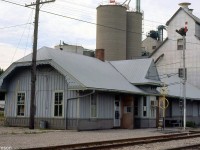 The Chesapeake & Ohio's Blenheim station is pictured on July 26th 1984, tucked in beside Taylor Grain & Feeds.