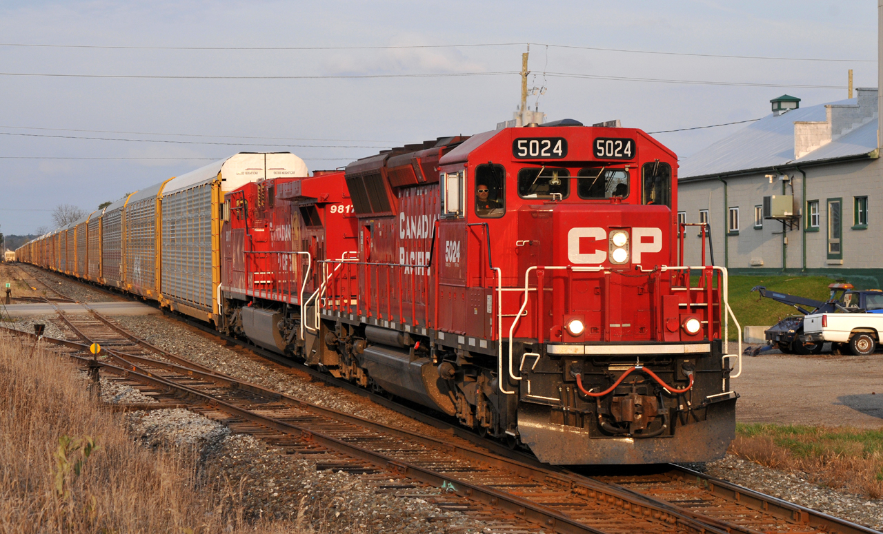 CP SD30C-ECO 5024, and recently repainted AC4400CW 9817, lead 147 through Ayr, ON with 37 autoracks in tow