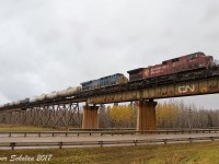 CN and CP have been sharing power on co production trains into Vancouver's Thorton Yard as of late. Although the CP power usually stays within the province of BC, on a cloudy October morning we find a couple units have wandered west on CN's Edson Subdivision. Running as CN train A412, this eastbound freight crosses the Magnolia Trestle near Gainford Alberta.  