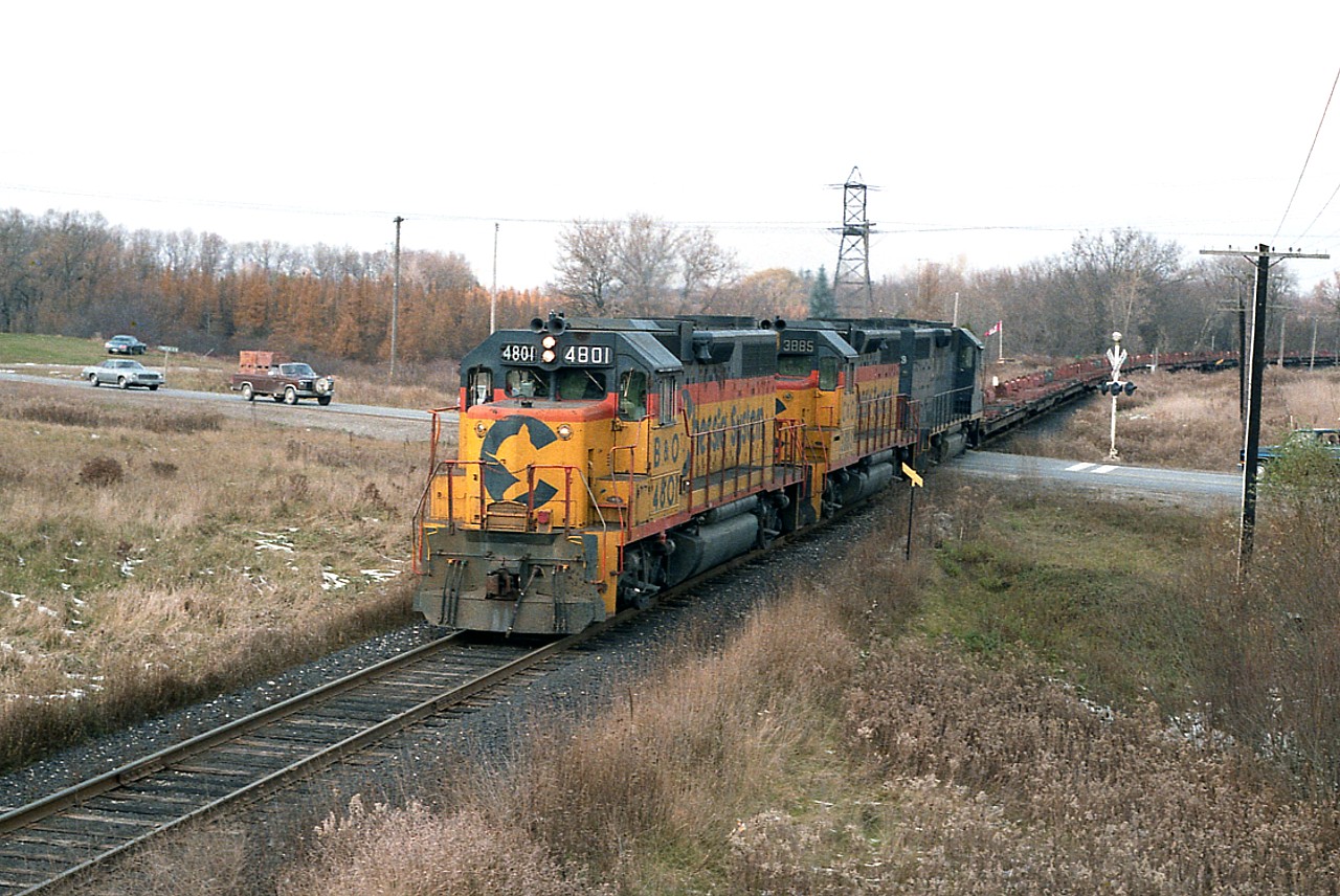 If you happen to be driving along Hwy 52 between Copetown and Hwy 403, it is hard to imagine coming across a scene like this. But it once was. Now, the location is overgrown with brush and good sized trees, the railroad is no more; it is now the quiet Hamilton-Brantford Rail Trail. This is former namesign 'Summit' in rail terminology but the actual closest settlement would be Jerseyville. B&O 4801, C&O 4885 and 4828 with the Steel Train for Nanticoke and just about everything else in this image save for the highway is now a part of history.