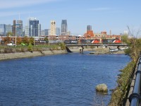 A pair of surprisingly clean and repainted widecab geeps (CN 9584 & CN 4772) lead CN 586 with mixed freight as well as emty TankTrain cars from Brockville over the Lachine Canal about ten minutes after QGRY detour CN F900 passed.