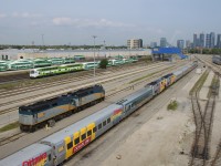 Cab car GOT 331 leads a deadhead move west past a pair of F40's (VIA 6417 & VIA 6420) which are heading east light and some parked VIA Rail equipment at the Toronto Maintenance Centre. On the other side of the Oakville Sub is GO Transit's Willowbrook maintenance facility 