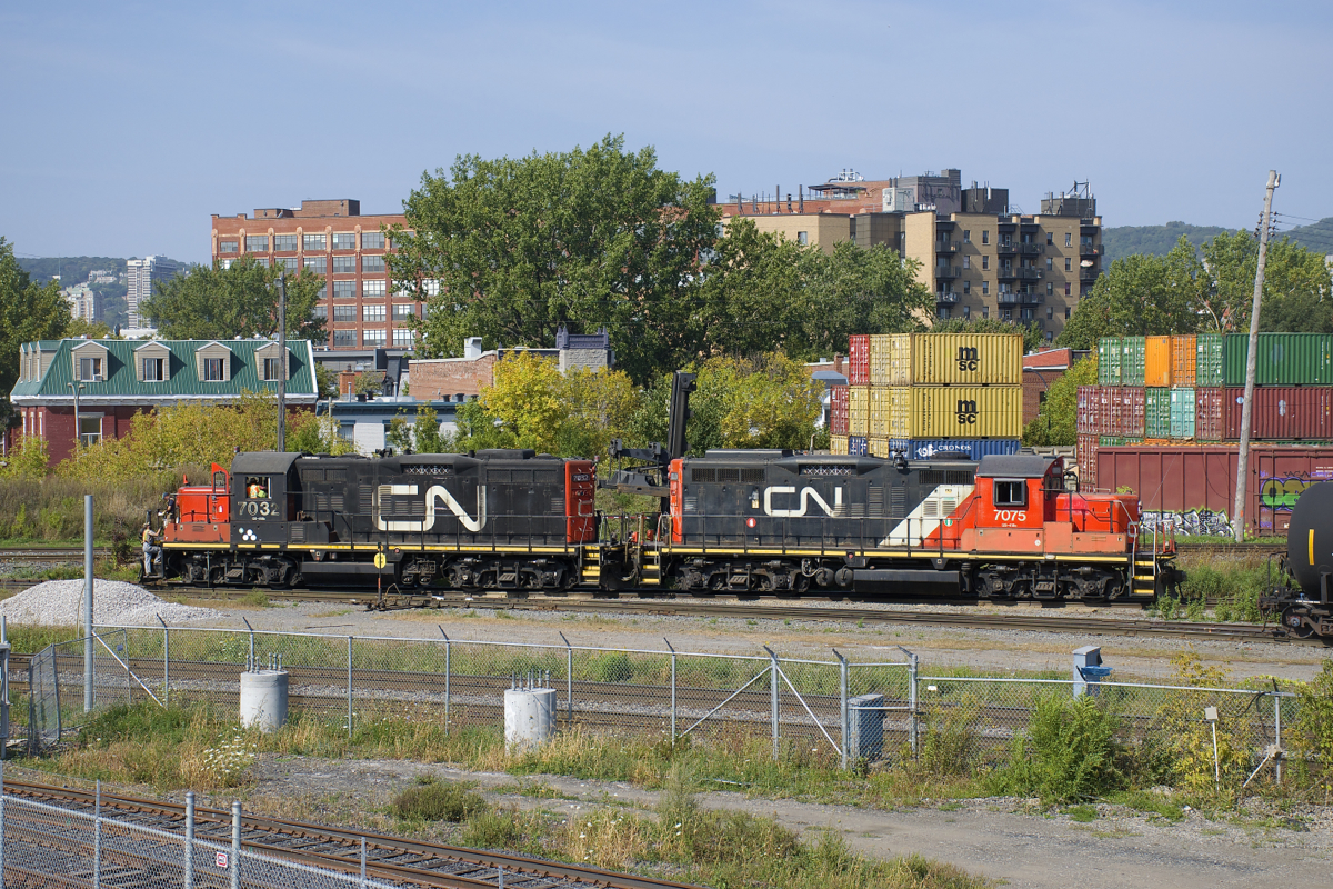 A pair of GP9's (CN 7075 & CN 7032) with noodles of varying size on their long hoods work the Pointe St-Charles Yard.