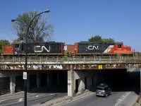 A pair of GP9's (CN 7075 & CN 7032) work the Pointe St-Charles Yard as they cross Wellington Street.