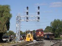 Loaded ethanol train CP 650 with CP 8635 leading is passing a dynamic track stabilizer by Lasalle Yard. Normally CP 650 is on the west track of the CP Adirondack Sub but with quite a bit of work on the west track it's running on the east track. At right are four multimarked but heavily tagged CP hoppers.