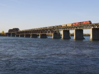 CP 651 with a unit train of empty ethanol tank cars from Albany is crossing the St. Lawrence River onto the island of Montreal a bit over an hour after sunrise with ES44AC's CP 8877 & CP 8873 for power