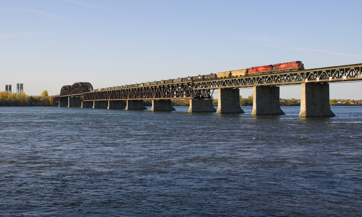 CP 651 with a unit train of empty ethanol tank cars from Albany is crossing the St. Lawrence River onto the island of Montreal a bit over an hour after sunrise with ES44AC's CP 8877 & CP 8873 for power