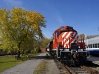 CP 1608 and a CN coach are resting in front of Hays Station at Exporail. At right is an AMT coach.