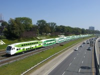 Fairly new cab car GOT 354 leads a 12-car train westbound along the Oakville Sub.