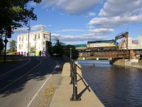 A slightly late VIA 69 crosses the Lachine Canal and passes Wellington Tower with VIA 6443 for power.