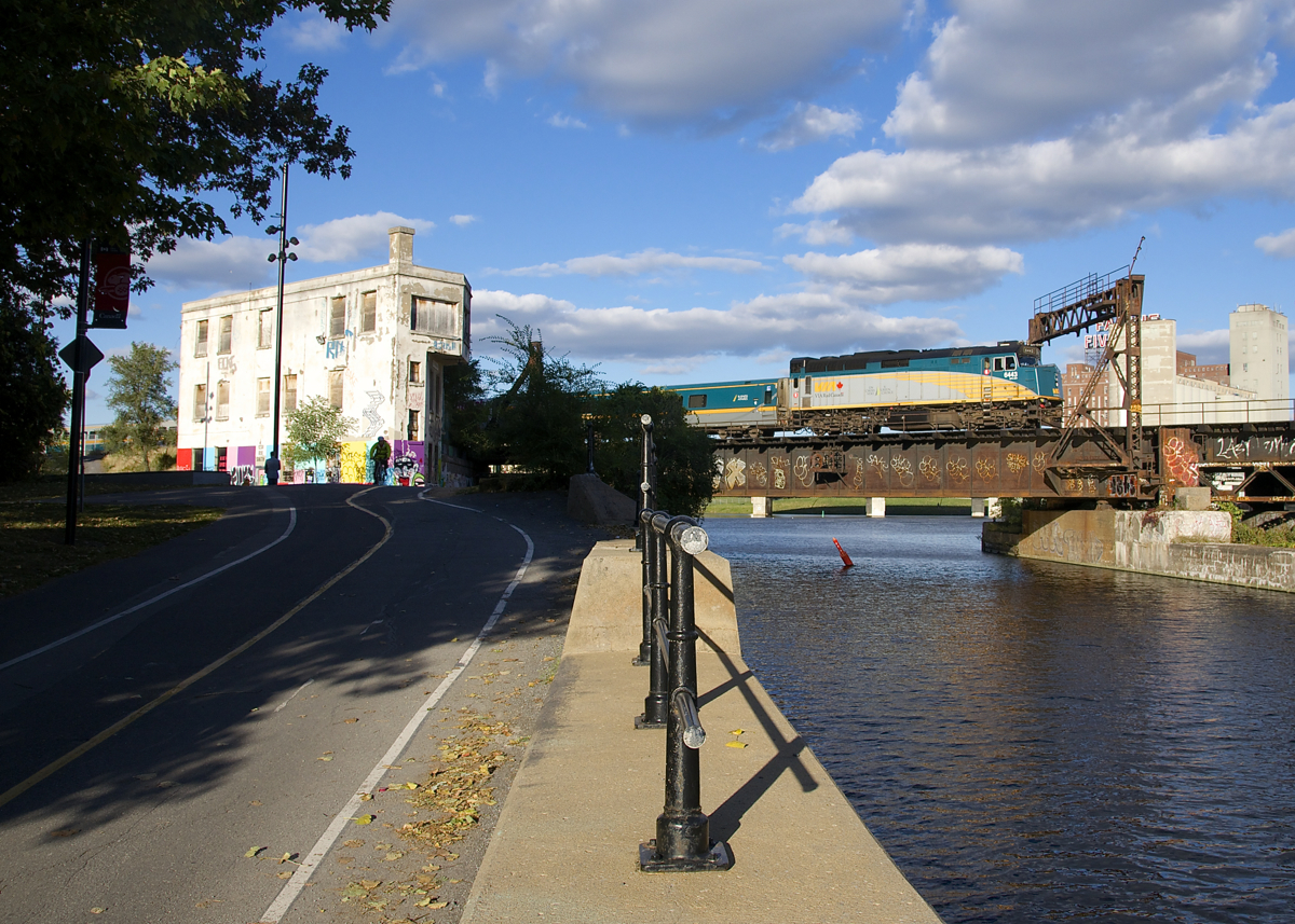 A slightly late VIA 69 crosses the Lachine Canal and passes Wellington Tower with VIA 6443 for power.