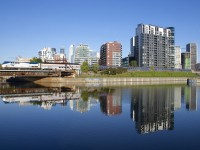 As happens every fall, the Amtrak <i>Adirondack</i> has the great dome car <i>Ocean View</i> for a month, three times a week northbound and three times a week southbound. Here the train deadheads towards Montreal's Central Station about eighty minutes before its departure, passing the Peel Basin, where a number of condos and hotels are reflected in the fairly still waters.
