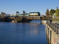 VIA 33 from Quebec City is crossing the Lachine Canal with VIA 6446 leading as it approaches Wellington Tower.