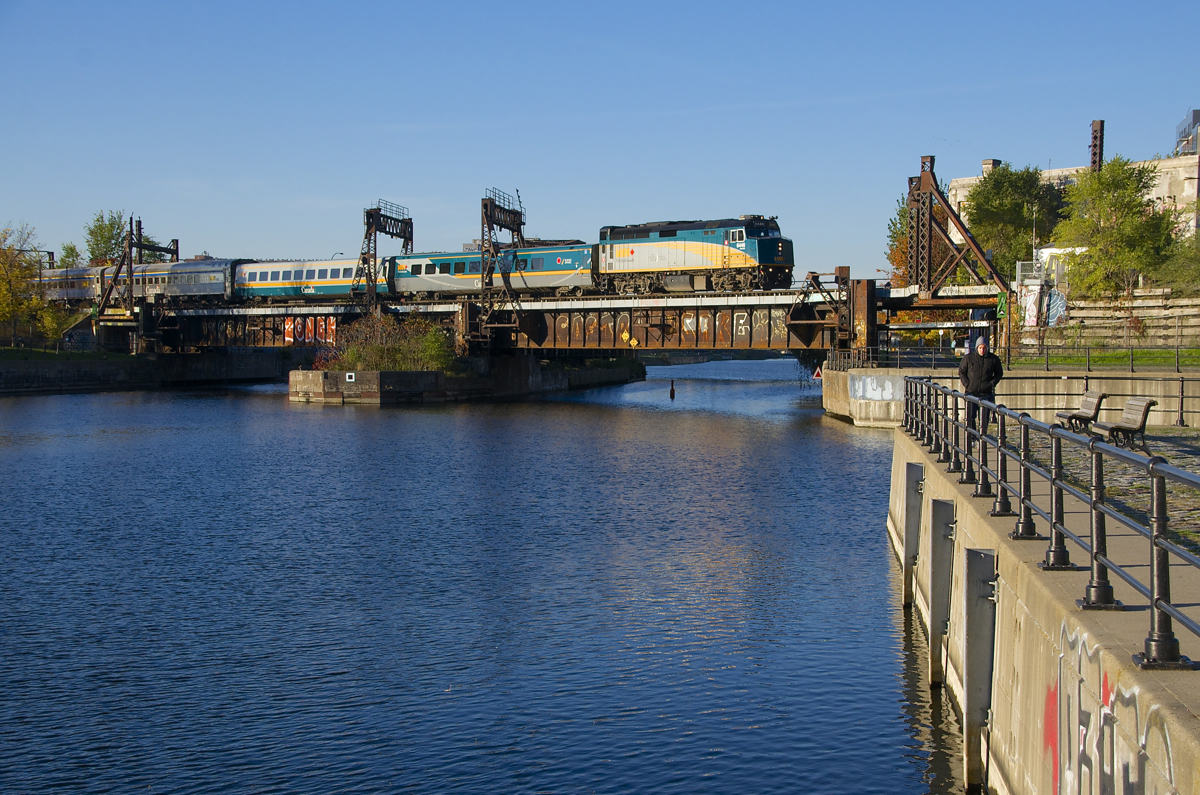 VIA 33 from Quebec City is crossing the Lachine Canal with VIA 6446 leading as it approaches Wellington Tower.