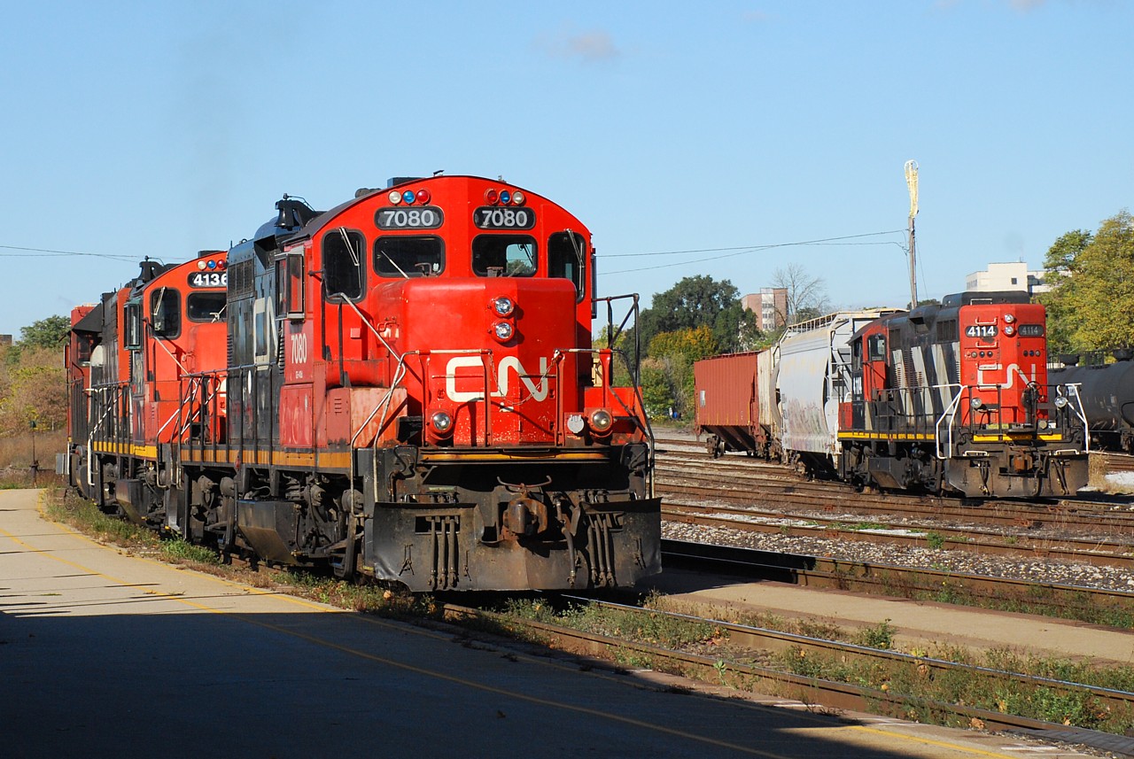 GP9s Galore.  CN 385 stalled on Dundas Hill when their second unit, IC GP40 3117, decided it wasn't up to the task.  Local power from Aldershot was summoned to push the train to Paris.  The GP38-2 / GP9RM / GP9RM consist is seen shoving hard on the rear of 385 passing CN 4114 in the yard.  Once 385 cleared, 580's crew got on board and departed the yard to switch Normerica.