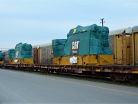 A trio of flat cars with diesel engines from Caterpillar roll through Agincourt Yard