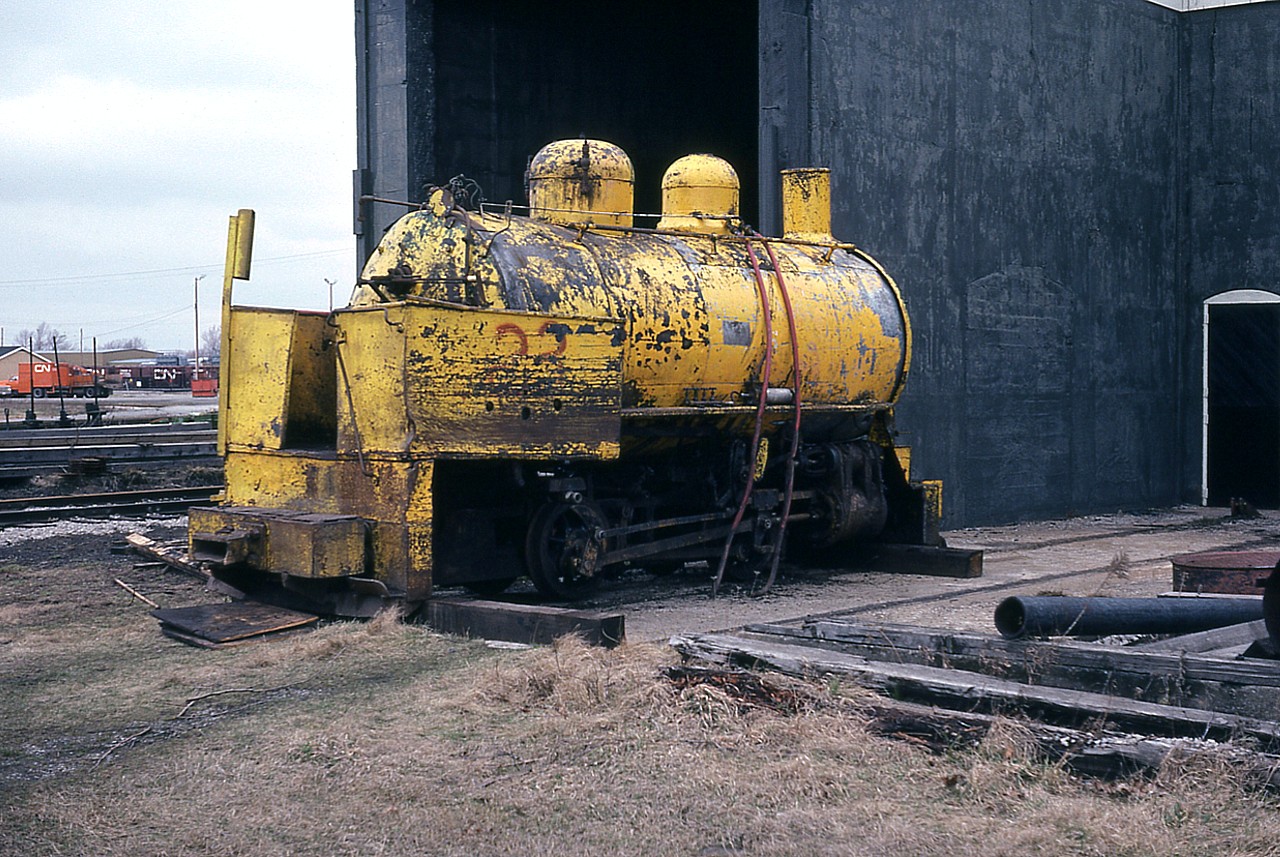 Here is a real historical piece!! This is a Fireless locomotive, one of only two of such locomotives left in Canada. It is a 30" gauge, and was used by Atlas Steel in Welland for many years. The idea of the 'fireless' is that it uses compressed air or steam, supplied by an external source. This is for when a loco is needed for use in confined areas, such as in buildings or mines, where fumes from a conventional engine might be too risky. Modern examples of such are now battery-operated electrics and most old fireless units of this type have been scrapped. From what I could find on-line, this unit was donated to Fort Erie Railway Museum in 1984, as delivered from Atlas. However, I shot this next to a open-ended brick building at CN Fort Erie shop in early 1983. From what I gather, the museum did not want it any more and it was going back to Welland but a deal with the fledgling Niagara Rail Museum resulted in it coming back to the location of NRM in the old CN diesel shop in 2014. It arrived painted black. Plans are to restore it and give it new paint.