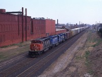 There was a period of time in the late 1990s when CN did have a bit of colour in their consists. Here is westbound #332 out of Fort Erie with CN 5335, EDMX 6419 and CR 6482 as seen from a pedestrian walkway over the tracks that connects severed Emerald St. N. In the distance is the Wentworth St grade crossing. I used this location sparingly. Not exactly a neighbourhood I felt overly safe in.