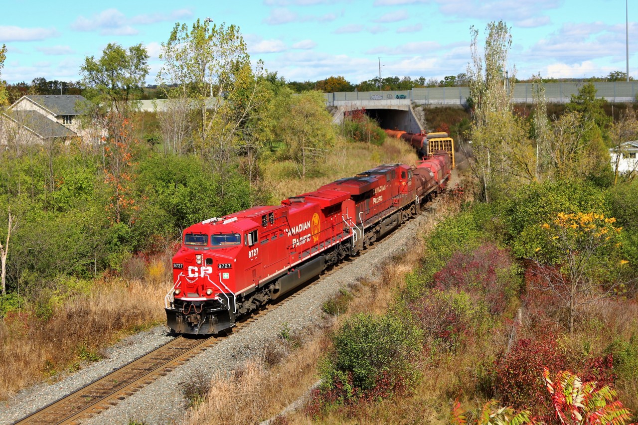 It was sure nice to actually see bright red on a CP locomotive for a change when CP 246 passed me in Milton, and so the chase was on. I decided on this picture as the sun finally poked out from between the clouds. Here, CP 246 lead by a completely refurbished CP 9727 with its faded mate in CP 8755 glide out from under Highway 6 approaching the Newman Road overpass on the way to Desjardins.