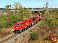 It was sure nice to actually see bright red on a CP locomotive for a change when CP 246 passed me in Milton, and so the chase was on. I decided on this picture as the sun finally poked out from between the clouds. Here, CP 246 lead by a completely refurbished CP 9727 with its faded mate in CP 8755 glide out from under Highway 6 approaching the Newman Road overpass on the way to Desjardins. 