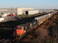 The SD70I's have always sparked a certain interest for me, most likely because they were the first units I got to photograph brand new. CN ordered only 26 of them before taking in countless similar looking SD75I's with a slightly higher horsepower rating. The shadows are seen growing very long between Milbase and Mansewood at Milton as CN train 394 headed by SD70I 5612 still in its as delivered paint rolls eastward with BC Rail Dash-9 4648. The train is passing the Whirlpool warehouse in town that is often served by CN local #551.