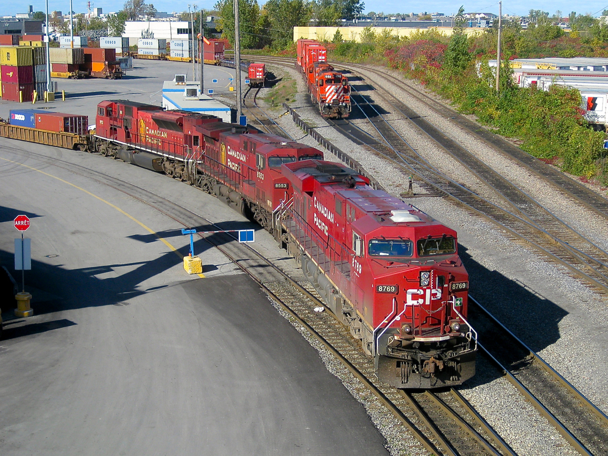 CP 8769, CP 8553 and SD9043MAC CP 9113 lead an eastbound through Lachine IMS yard, as a pair of GP9's (CP 1690 & an unknown mate) look on. Since then the GP9's have all been retired and the SD9043MAC's stored, unlikely to ever see service on CP again.