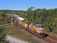 FPON on CN. With the oil boom over for quite some time now, it's been quite difficult to catch such a thing. While it isn't exactly rare even now, most FPON on CN has tended to run under the cover of darkness. Foreign leaders are a special treat though. If there was any train this would occur on, a Canada bound express autorack train definitely has the highest probability, likewise on CP. I had yet to get a photo of a foreign leader on CN, but the time finally came.
<br><br>
With the clouds playing with my nerves, this shot was luckily spared. UP 5876 and 8948 do the honours taking 80 empty racks to Oshawa. I would've loved to chase this to Beare, but CN had another stellar lashup coming. Having to forfeit one chase to see another great lashup. Not something you'd expect in 2017.