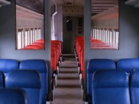 COMFORTABLE COACH. The interior of Terra Transport Coach 764 is captured on April 16, 1988 as Mixed Extra 935 West casually cruises through the former Flag Stop of Lake Bond in the 1947 Newfoundland Railway Timetable. Having been taken out of service for the prior 3 months following a CTC ruling that saw the mixed cancelled for the winter months, it and the baggage car were restored to pristine condition by the TT Shops in St. John's. Built in 1949 by the Canadian Car and Foundry as coach No. 47 for the Newfoundland Railway and later renumbered 764 under the CNR, the large and extremely comfortable blue and red reclining seats made for a most pleasant travelling experience over the 138 mile journey from Bishop's Falls to Corner Brook that day. On board were only the photographer and his friend Paul, taking a well deserved break between the winter and spring semesters at Memorial University. They would later be joined by a cabin owner at Millertown Junction until he detrained at Gaff Topsail in several feet of snow.