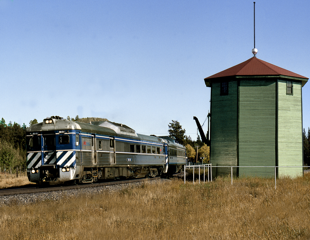 BCOL southbound train 2 passes the preserved water tank at Lone Butte in B.C.'s Cariboo district