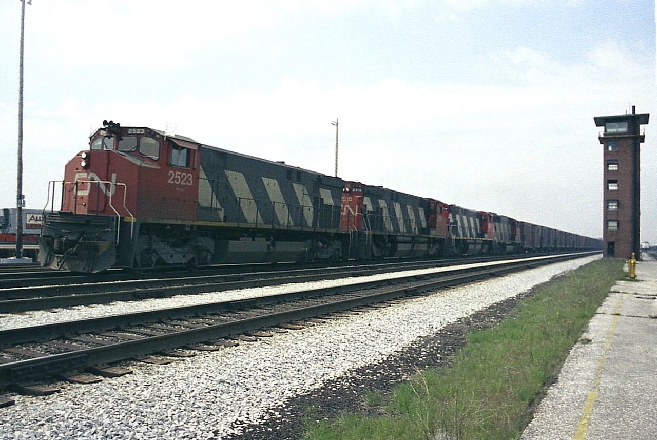 This location is known to the fans these days as the VIA Rail Maintenance facility/Willowbrook, near where also Toronto and GO facilites are located. However, before that, this was the location of that sprawling CN Mimico freight yard, a facility that eventually outgrew itself and was relocated to what is now MacMillan Yard up in Concord. The Mimico days were winding down around the time I shot this image of eastbound CN with three M420s and what looks to be a GP40 with a long string of boxcars passing the Tower. A modern day shot at this angle would be overshadowed by the Islington Av overpass, which would be not far behind the tower. I get the idea that this must have been one 'sooty' place back in the days of Steam. :o)