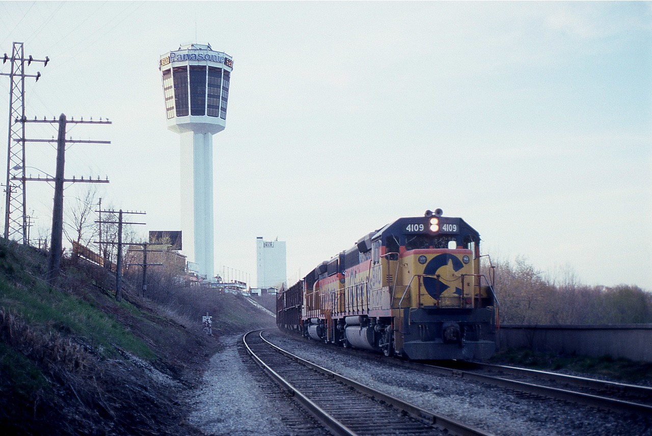 Late day, low light, but still not a bad image........CSX #321 with 4109 and 4396 makes its way west thru Niagara Falls by Portage Av, coming up to the Siding Switch Chippawa. I thought that was the Minolta Tower, but it reads Panasonic, and who knows what they call it now. If the clock is right, it is 5:29 PM when I shot this. The area is unrecognizable these days; tracks are long gone and tourist towers (hotels) have sprung up all over the place.