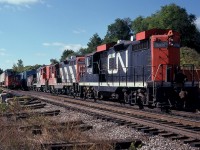Busy mid-morning down at Bayview on this nice fall day as a train Hamilton-bound passes #451 which is waiting a light at the Junction. GP9 CN 4514, still wearing its' snowshield apparatus, leads mates 4588 and 4515, and once it gets a light, is bound for Aldershot.
