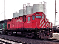 MLW C424 CP 4210 is parked at the east end of the Diesel shop tracks on this dreary Sunday morning. The fuel tanks behind it are long gone now.