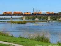 It would seem this train has quite the audience, as a flock of Canada Geese face the menacing orange beast, and a group of birds at the right are about to take flight. Fishermen are also in the water enjoying the beautiful day, and us rail-nuts were flocking to the banks of the Grand River snapping photos of this rather interesting and rare morning move. <br><br>I chose this scene as I've seen it dozens of times in the last decade driving through Caledonia for Port Dover and I'd consider this a bucket list shot, a rather pretty location and a nearly perfectly matched train including the Schabel. You can count on one hand how often SOR runs through here in the morning in daylight on an annual basis, let alone a beautiful day like this. To me, you just can't beat this folks, this is my train heaven. <br><br>
To facilitate this move 597 ran light power to Brantford in the afternoon on September 30 (after CN dropped the car off in the morning) and parked for the night in Brantford yard. Hydro one crews must be available to move the car and they already had a busy morning, so after rest, Hydro One crews reported for duty at Brantford for 0800 on October 1, SOR crews arrived by taxi around 0900 and the train got underway around 1000, passing Caledonia just before noon. For more on HEPX 200 see <a href=http://southern.railfan.net/schnabel/cars/hydro/hepx200.html> Tom Daspit's HEPX 200 page</a> which I contributed to 15 years ago..  the site even has diagrams and other technical details.