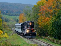 With mother nature angry as hell, winds blowing with 100 KM/h gusts, and a rainstorm over the Caledon Hills in the distance, Engr. Steve Bradley and his conductor Tyler are approaching the small town of Inglewood Ontario on the OBRY Credit Valley Explorer train.  At least there was some colour to be had if you looked hard enough.