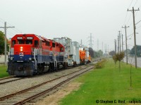 13 years ago a rather interesting move occurred out of Guelph.  Ontario Southland Railway sent a train early in the morning light power to arrive in North Guelph for 0600. Their task? Lift three dimensional loads out of ABB including HEPX 200 and deliver 1 mile to the GEXR interchange, where GEXR would meet OSR and continue the journey. In this scene, a few hours after interchange GEXR is heading south on the former CNR Fergus subdivision without any spacers at all - no bridges! GEXR would add spacers in Guelph Yard a mile to the south before proceeding west for Stratford. In moments, the train would stop to pass a rather precarious sideline obstruction, seen <a href=http://www.railpictures.ca/?attachment_id=30874 target=_blank> here </a><br><br>ABB closed in early 2006. We had it good in Guelph, HEPX 200 would come a couple times a year to bring transformers to be refurbished and take them back out.<br> For more on HEPX 200 visit <a href=http://southern.railfan.net/schnabel/cars/hydro/hepx200.html target=_blank> Tom Daspit's site</a> where I had (about 15 years ago) submitted photos taken a couple years earlier than this. To see this car today, check  out <a href=http://www.railpictures.ca/?attachment_id=30873> this photo</a>