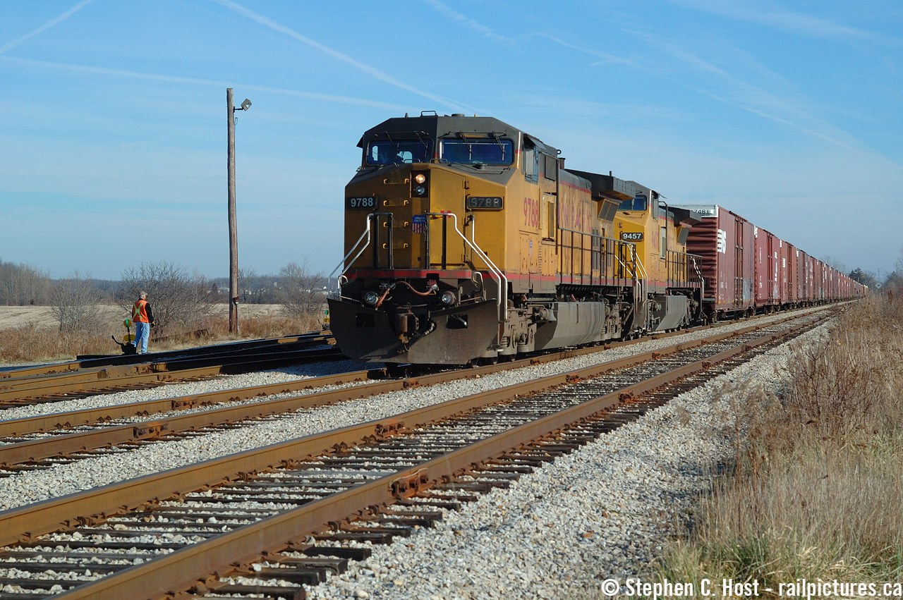 And in one of the few times I chased NS 327 to Talbotville, this chase was with Jason Noe and Jason Bartlett and we chased it to St . Thomas from Paris following all the way. Since NS 327's power tended to be a suprise, we only needed a Kodachrome sky (as some say) to proceed with the day's activities. I actually would have preferred NS power but heck, who cares, right - two UP's ain't too bad. A history lesson for the young-ins, the Payne sub (formerly known as Chatham subdivision) and the Cayuga sub were once known, as a combined entity as the Canada Air Line Railway which the Wabash was granted rights from the Grand Trunk in 1897. These weren't any rights, they allowed joint and equal access to solicit customers which is VERY rare. After the Norfolk and Western and Norfolk Southern mergers, NS continued to use these rights, servicing customers in Canada until 1996 when CN desired abandoning the Cayuga sub and NS went the long way as CN had to offer a route.  (The new route was the Stamford, Grimsby, Oakville, Dundas, Talbot subs). NS had access to customers even still through Trillium Railway and CN (CN provided the last mile of service to Ford) The Payne and Chatham subs continued to be used until 2004 when the west end trains were abolished to Detroit, but this segment in St. Thomas was the western end of what remained of the Payne in service and I desired shooting NS on their original route.  Mission accomplished.
The Stamford from Draw (in the US) to Robbins (via Fort Erie) is the other section of the original Air Line route still in use by NS and continues to be used to this day by the daily NS Transfer as far as CN Duff.
