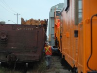 <b>Walking Speed for HEPX 200</b> Hydro One and GEXR employees watch carefully as a trio of Transformers pass loads of Utility Poles by mere inches in Guelph (D7R's passing D3R's basically).  HEPX 200 (pictured) can move left and right to avoid obstructions, as they stopped to do on this trip, after the shift they moved veeeeeeeeeeerrrrrrry carefully and veeeeeeeeery slowly. Next photo will show the entire train and I'll go into more detail on this move. <a href=http://www.railpictures.ca/?attachment_id=30875>Click here for next photo</a>  | <a href=http://www.railpictures.ca/?attachment_id=30873>Click here for a modern photo of HEPX 200 (2017) </a>