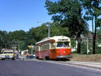 On a great sunny Sunday Summer's day to visit the nearby High Park, TTC PCC 4383 arrives at High Park Loop at the end of its Carlton run from Main Subway Station, passing one of the old yellow-painted Toronto Police cars parked nearby. A Peter Witt streetcar ("Tour Tram" 2766 signed up for Carlton, possibly in charter use) is visible heading to the loop in the background, on Howard Park near Parkside Drive.
<br><br>
<i>Robert McMann photo, Dan Dell'Unto collection.</i>