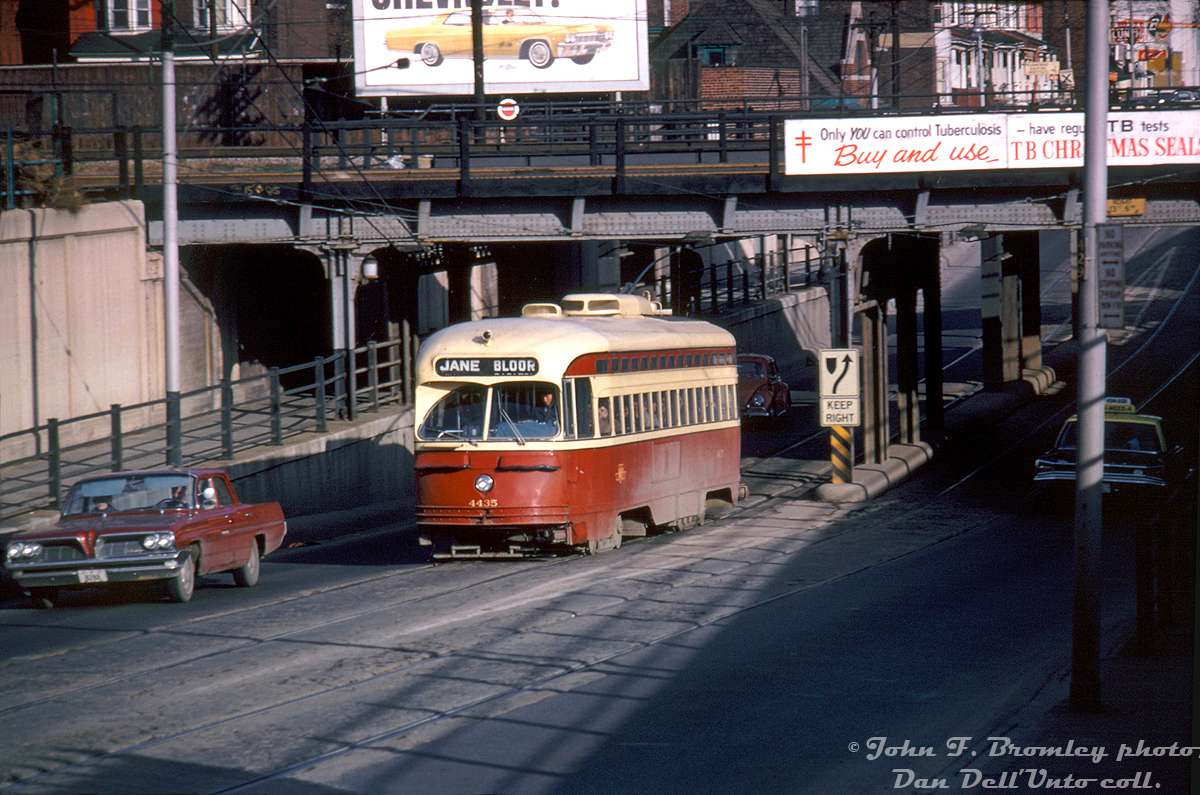 Popping out from under the series of CNR & CPR underpasses along Bloor Street West, Toronto Transit Commission PCC 4435 operates on the Bloor route bound for Jane Loop, heading westbound approaching Dundas Street West. Pre-subway opening, service along Bloor and Danforth streets was provided by streetcars, often operating in MU. The opening of the B-D subway line in 1966 nixed the crosstown streetcar route and caused a lot of the TTC's early PCC's to retire, but Bloor and Danforth streetcar "shuttles" operated at the west and east ends of the subway until extensions were opened two years later in 1968 (resulting in further streetcar retirements, with many being sent overseas to Egypt).

The old Bloor rail bridges (for the CPR Galt Sub, CNR Weston (nee-Brampton) Sub & CPR service track (nee-TG&B) are still present today, hosting mainly GO Transit, VIA, and Union-Pearson Express passenger trains that operate on the lines and stop at Bloor GO Station located here. The easternmost bridge (originally built for the Toronto, Grey & Bruce Ry, later CPR) was converted for use as the West Toronto Railpath after the right of way lay dormant for years.

John F. Bromley Kodachrome slide, from the Dan Dell'Unto collection.