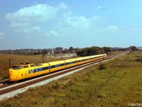 More Turbo action: VIA train #61 with its yellow and blue Turbo Train consist heads west at Pickering, along the Kingston Sub parallel to Highway 401, in August of 1976.
<br><br>
By 1978 it was felt that the Turbo was not the solution - the next phase was the LRC, which lasted a lot longer in VIA service.